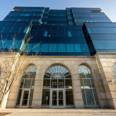 Exterior view of Vein Treatment Reston - Virginia, a modern medical office building under a clear blue sky.